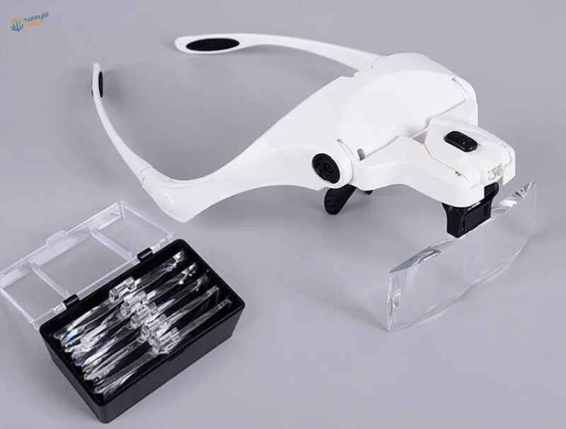 White adjustable LED light headband magnifier with 5 lenses and clear view