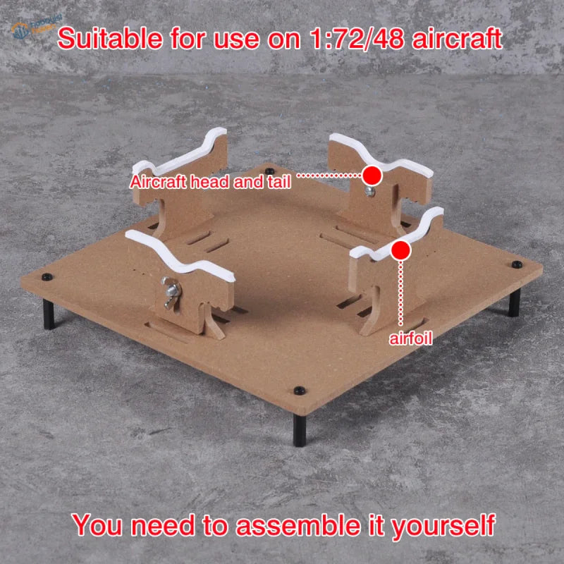Adjustable brown cardboard aircraft model painting stand with white plastic airfoil supports for precision hobby tools