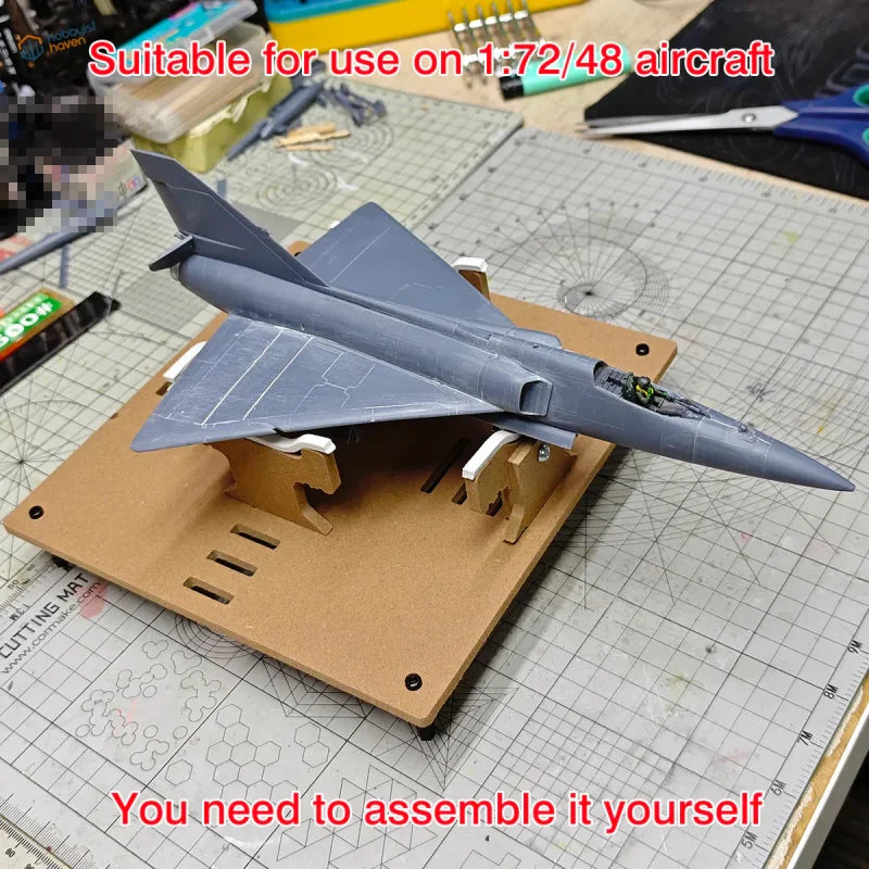 Gray plastic fighter jet model on adjustable aircraft model painting stand for precision hobby tools and scale modeling tools