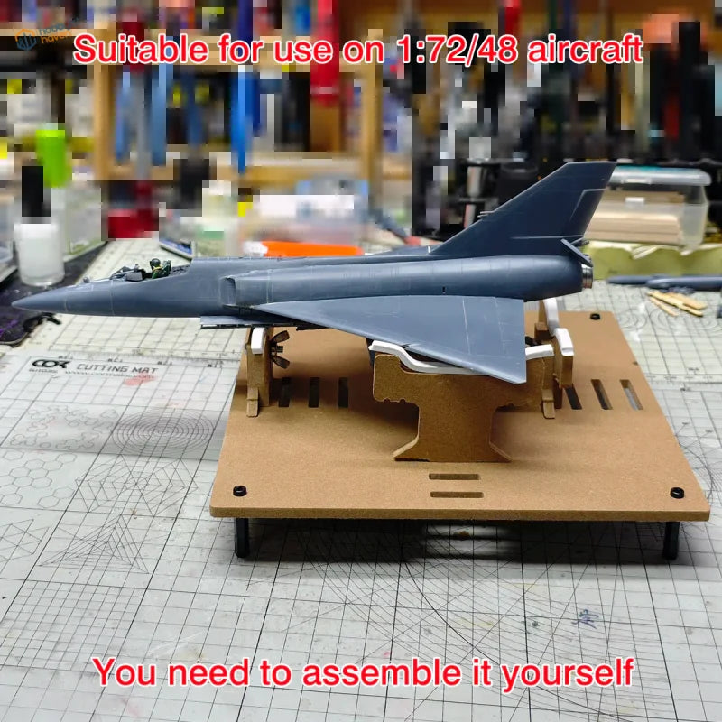 Gray 1 72 scale model airplane kit on adjustable wooden aircraft model painting stand for precision hobby tools