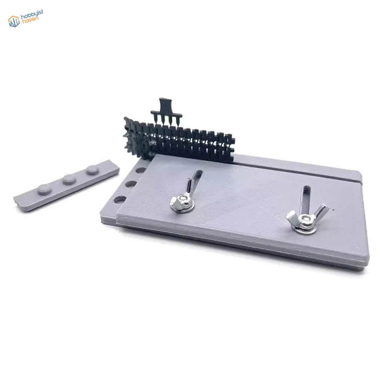 Gray plastic adjustable track building jig plate with wing nuts and holder