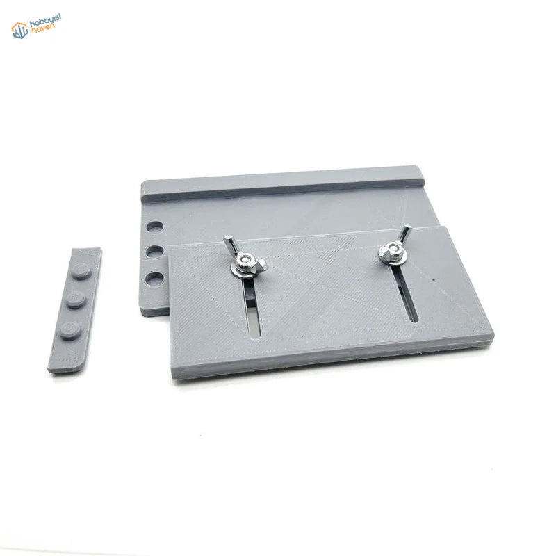 Gray 3D-printed adjustable track building jig plate with silver wing nuts