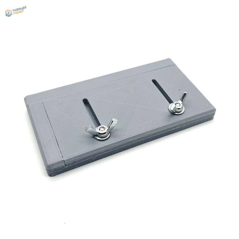 Gray 3D-printed adjustable track building jig plate with wing nuts and slots