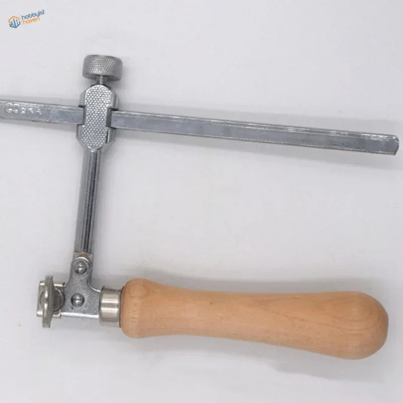 Adjustable wire saw with silver metal jeweler’s saw frame, light wood handle, and medium-tooth blades rated kit includes 12 blades