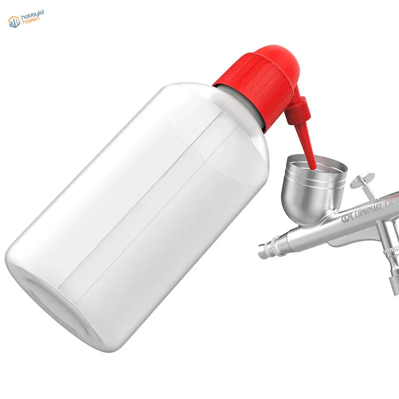 Airbrush cleaning bottle with clear plastic body, red cap and nozzle