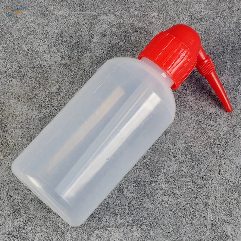 Transparent airbrush cleaning bottle with red nozzle and cap
