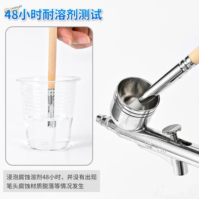 Silver airbrush cleaning brush with wooden handle and metallic nozzle