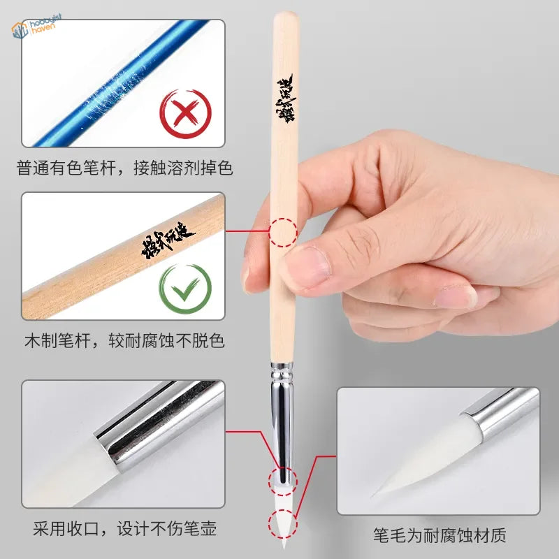 Delicate white airbrush cleaning brush with light wood handle and silver ferrule