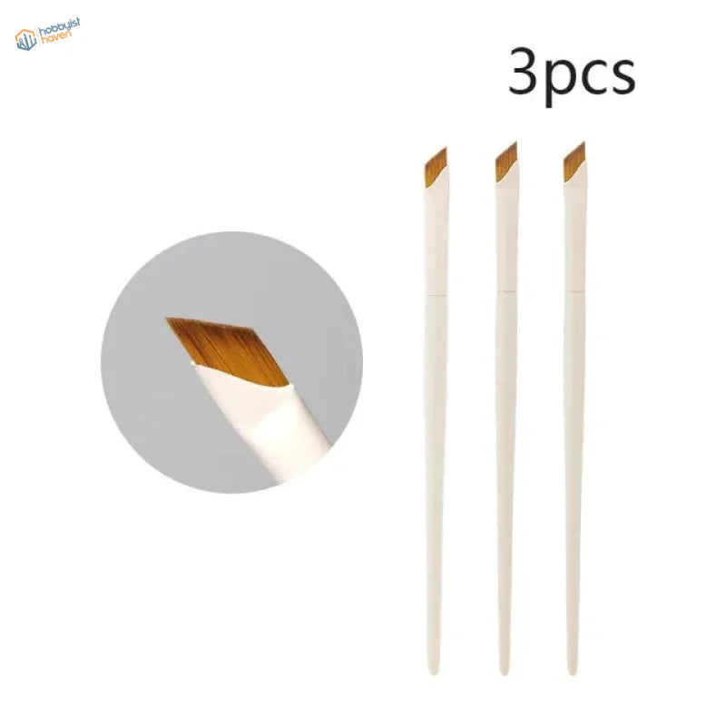 Set of three white angled liner brushes with wooden bristle tips