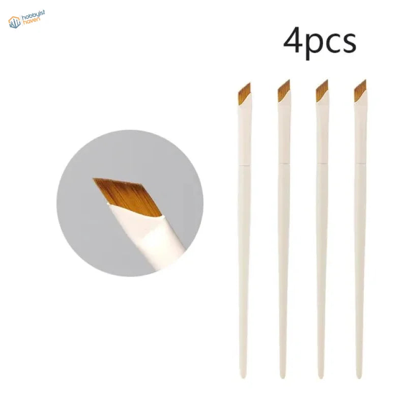 Set of four angled liner brushes with white handles and golden-brown bristles