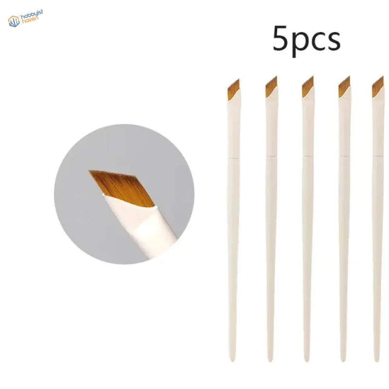 Set of five angled liner brushes with white handles and golden-brown bristles