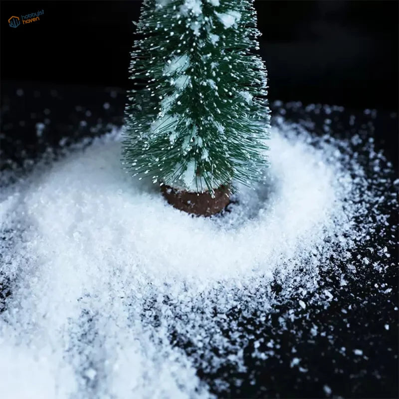 Miniature green Christmas tree dusted with artificial snow powder