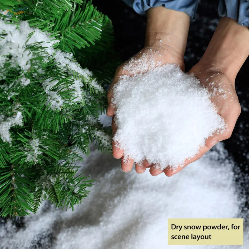 White fluffy artificial snow powder in hands with green pine branches