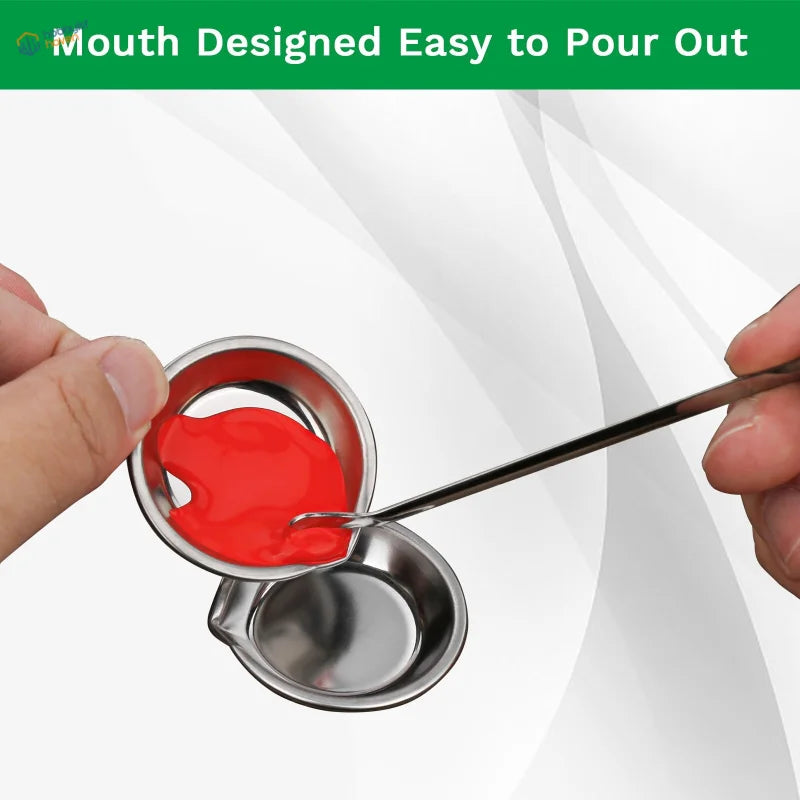 Stainless steel pouring cup with red liquid in assorted accessories set for paint mixing