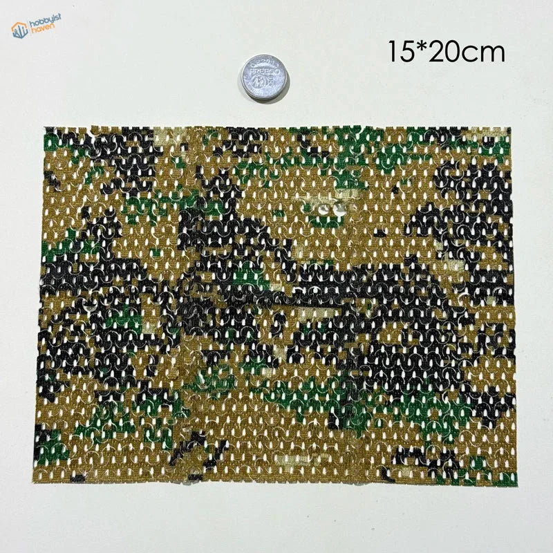 A rectangular piece of flexible cloth camouflage netting fabric in green black and tan for train layouts and dioramas