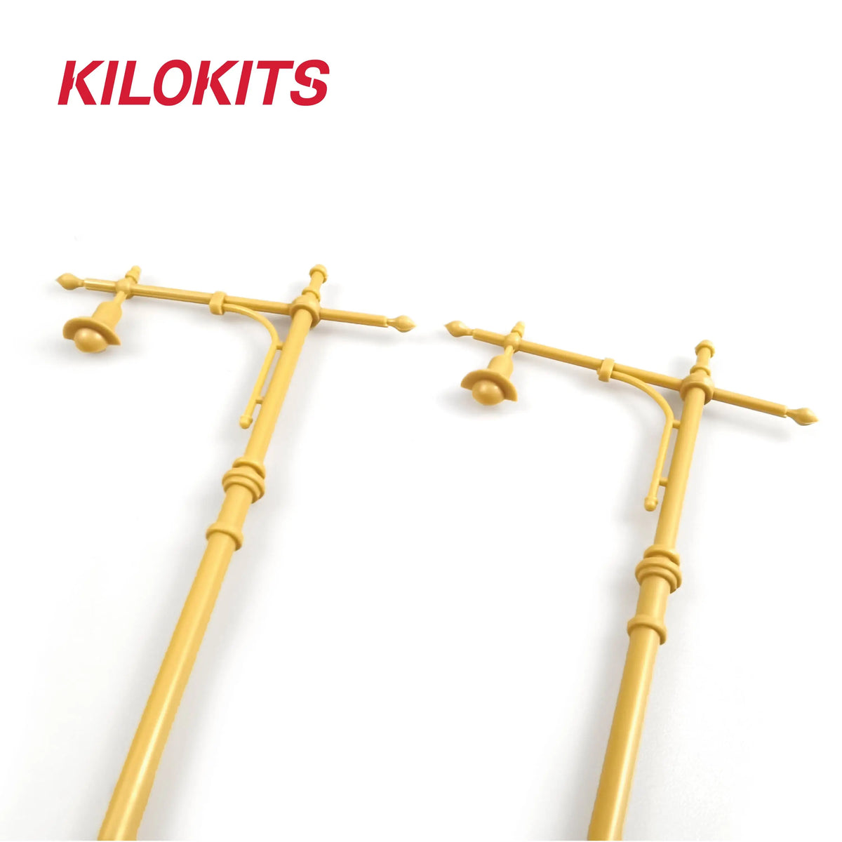 Two yellow plastic 1/35 scale street lamps with crossarms and bell-shaped light fixtures for model building tools
