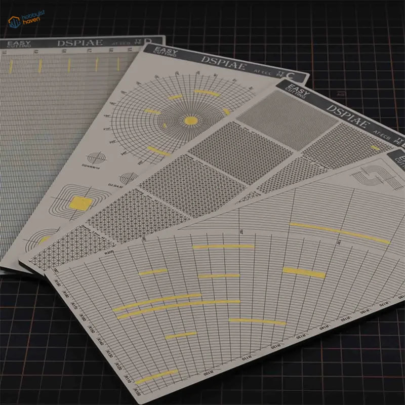 White and yellow DSPIAE masking tape cutting templates with grid mats