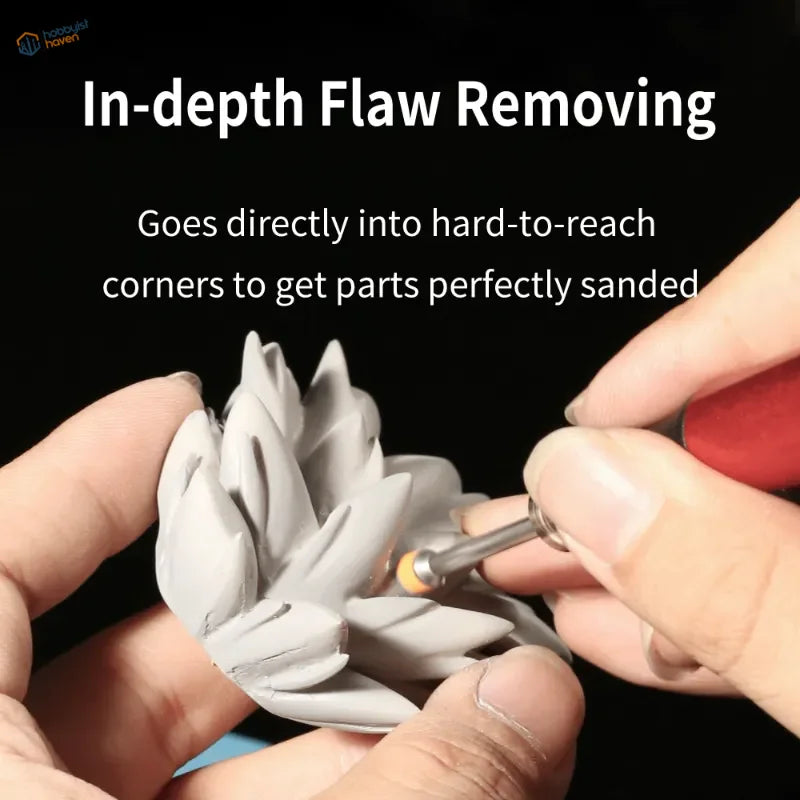 Sanding gray clay figurine with leaf protrusions using DSPIAE sanding disks for scale modeling