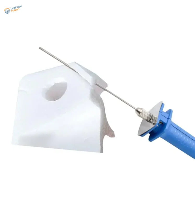 Blue-handled electric foam cutter with metallic blade cutting white paper