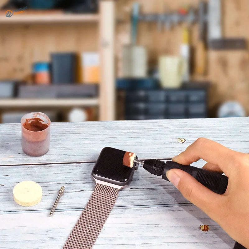 Electric mini drill repairing black Apple Watch with brown mesh band on wood bench, 220V EU plug