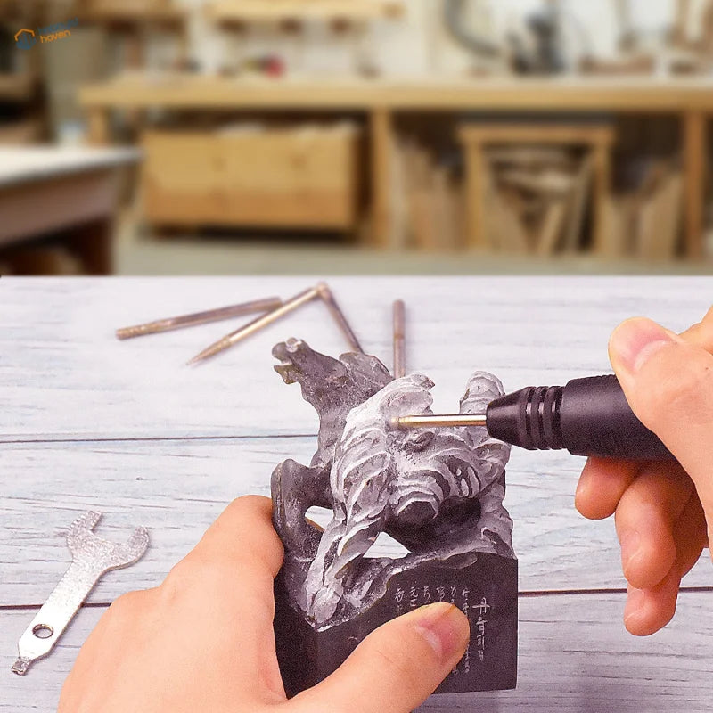 Electric mini drill with 220V EU plug refines grayish-white animal carving on black stone tool