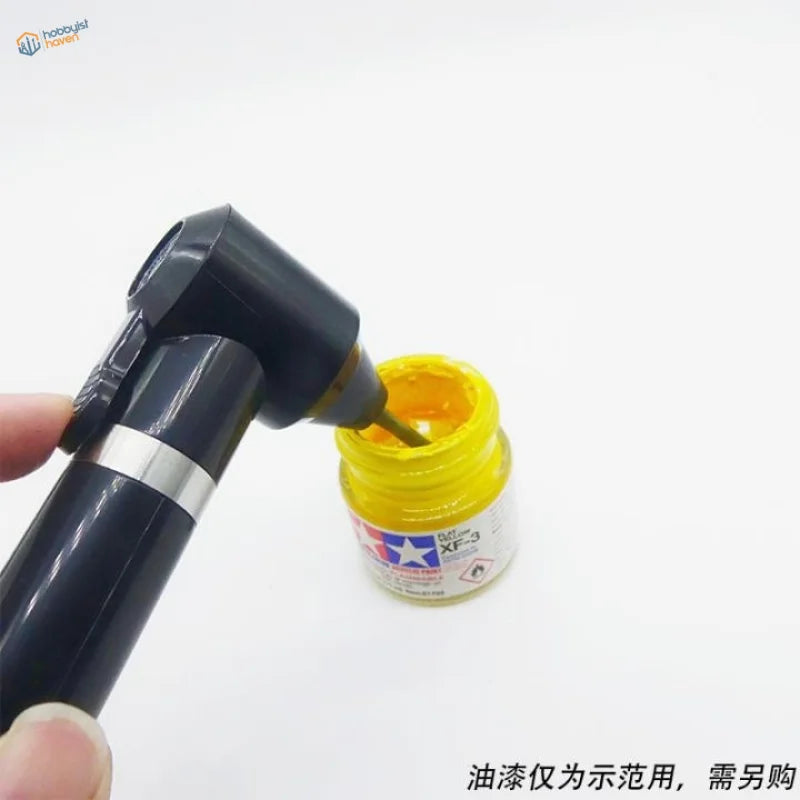 Black Tamiya XF-3 brush with silver accent dipped in yellow paint for electric paint stirrer