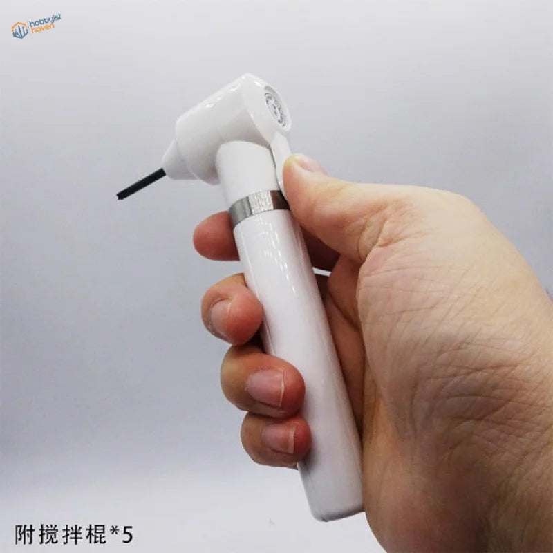 White electric paint stirrer handpiece with silver band in hand
