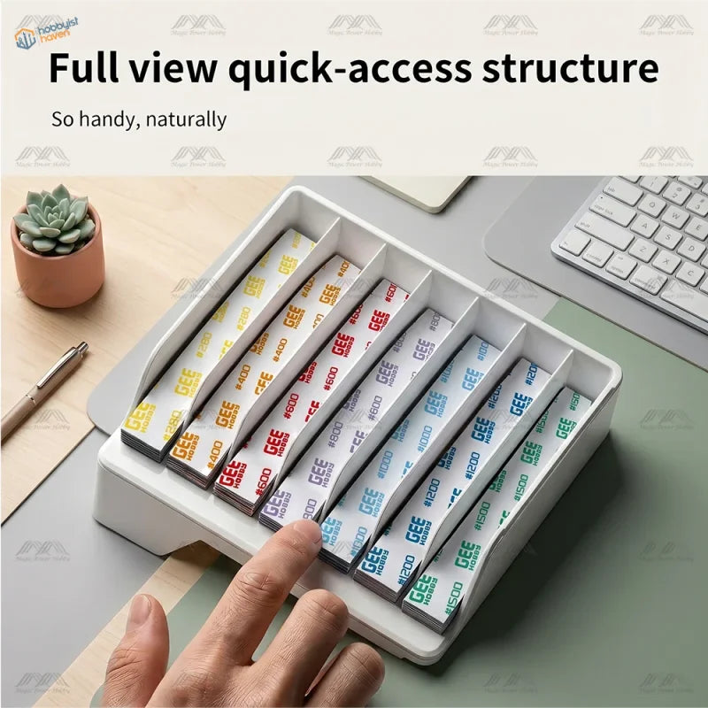 White plastic organizer holding neatly arranged stacks of gee hobby self-adhesive sandpaper grits x 20pcs for modeling with bonus toy kit and sanding sticks