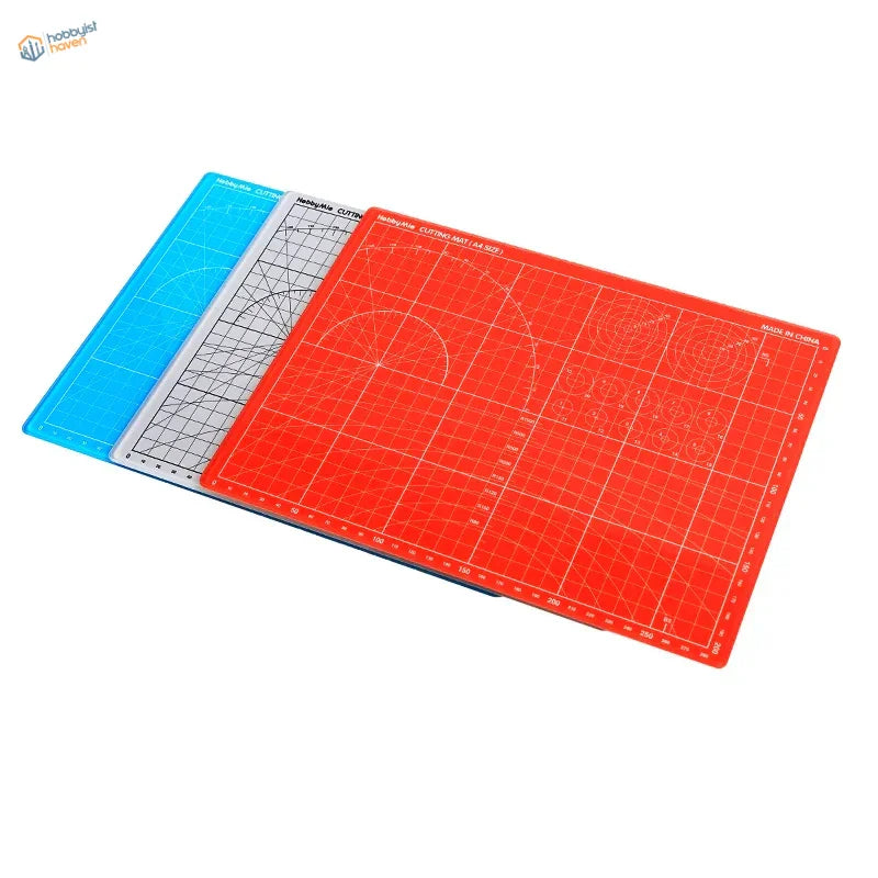 Set of three colorful glass cutting mats with grid markings