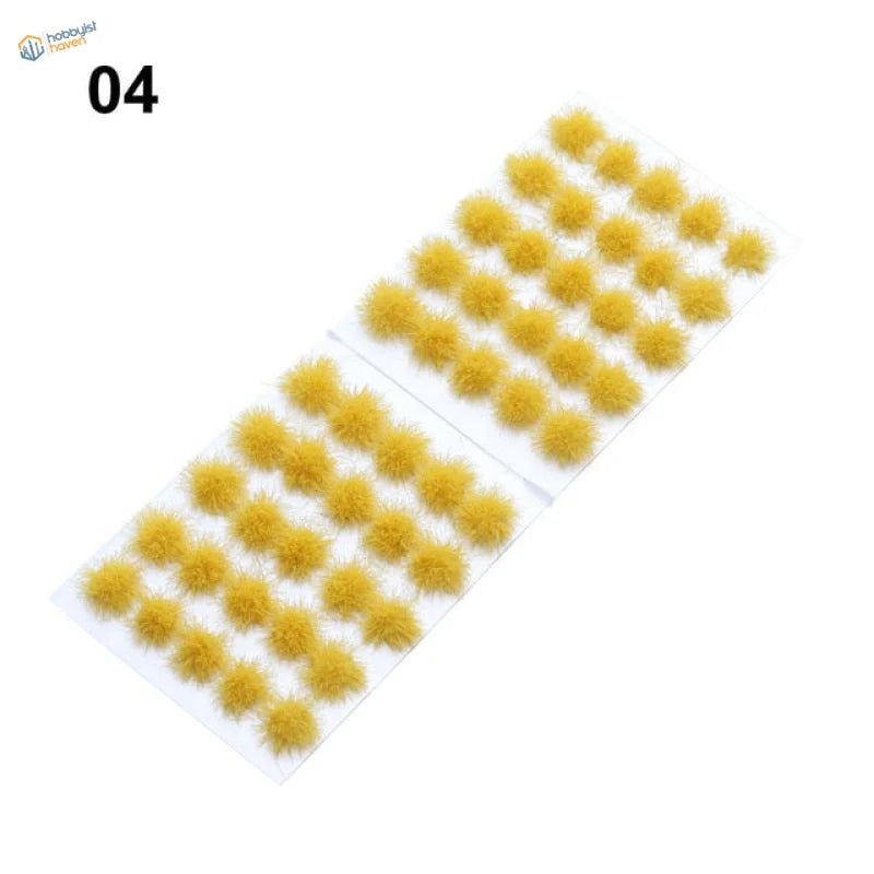 Yellow fuzzy pom-pom grass flower patches in rows on white adhesive sheet