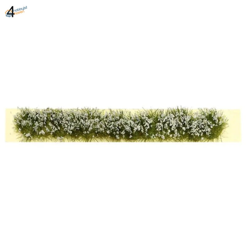 Detailed green and white miniature grass flower patch with realistic fiber texture