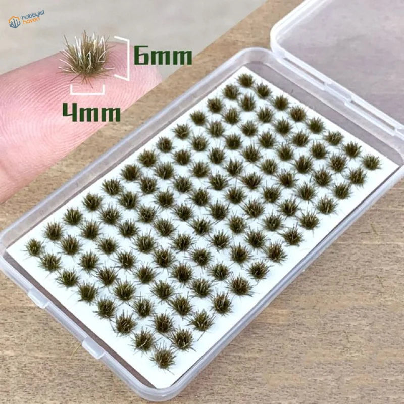 Clear plastic case of 60 green brown grass flower patches for model scenery