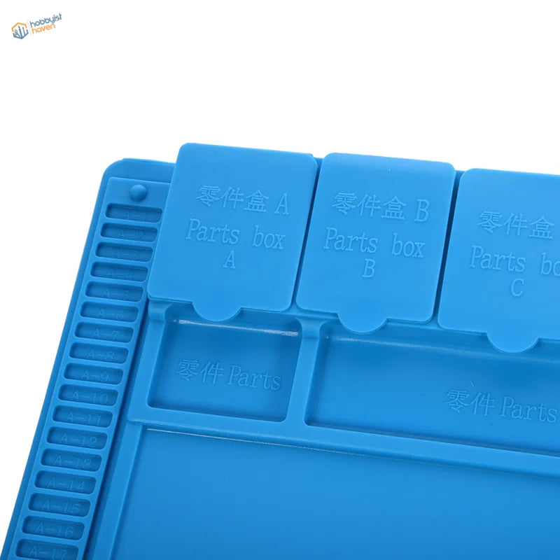 Blue silicone desk mat with labeled organizer compartments for soldering iron parts