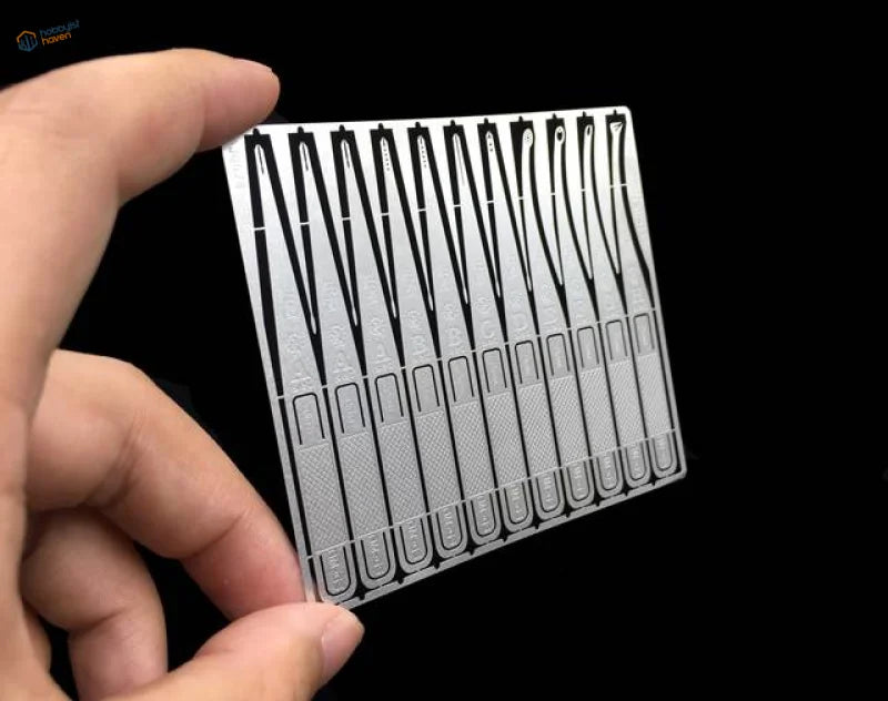 Silver metallic sheet with precision glue applicator cutouts for scale modeling tools