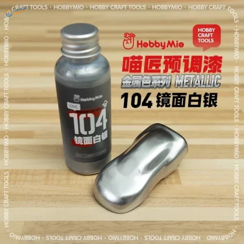 A sleek metallic silver 50ml bottle of hobbymie 104 oil-based metallic paint with matching cap and reflective sample for scale modeling tools