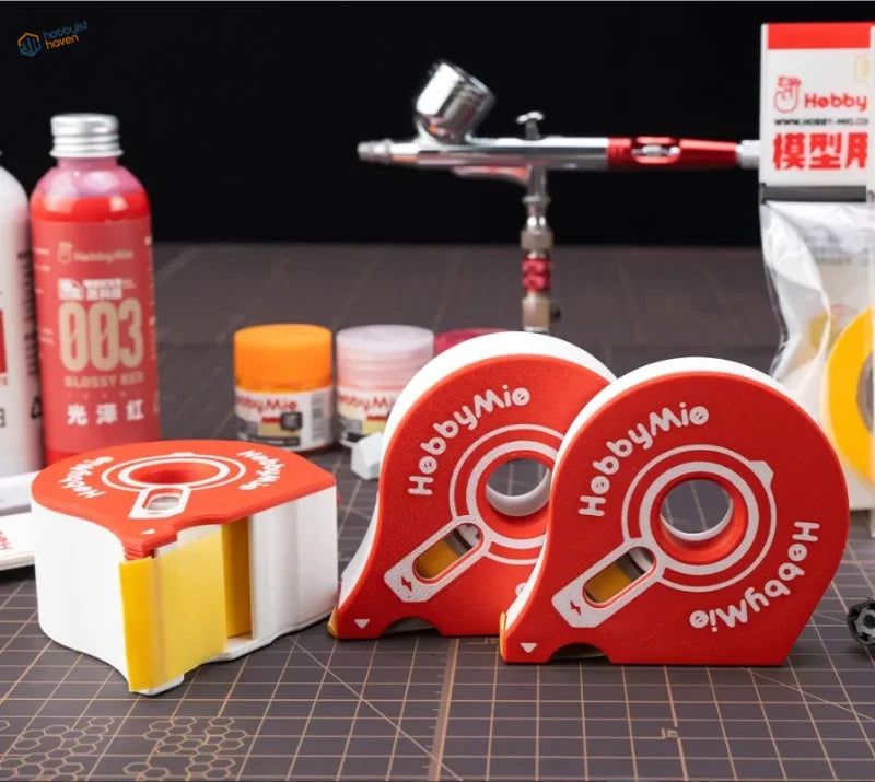 Red and white hobby mio individual masking tape cutters with yellow adhesive rolls designed to prevent tangled roll slows