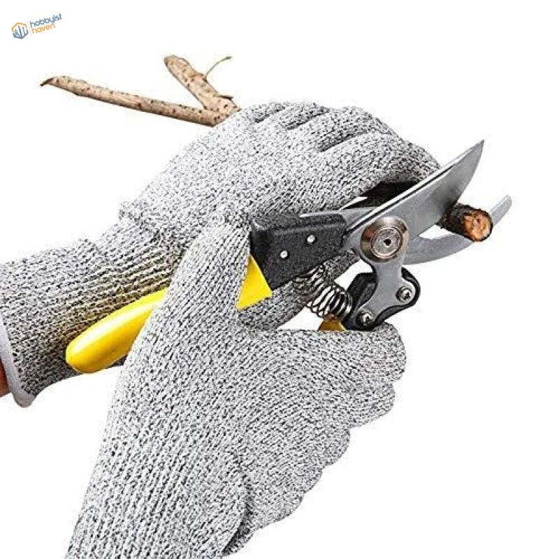 Yellow-handled pruning shears trimming branch with Level 5 anti cut gloves