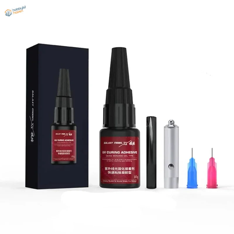Black bottle of rapid-curing UV glue with tools for scale modeling