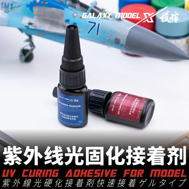 Black plastic bottles of rapid-curing UV glue for scale modeling tools