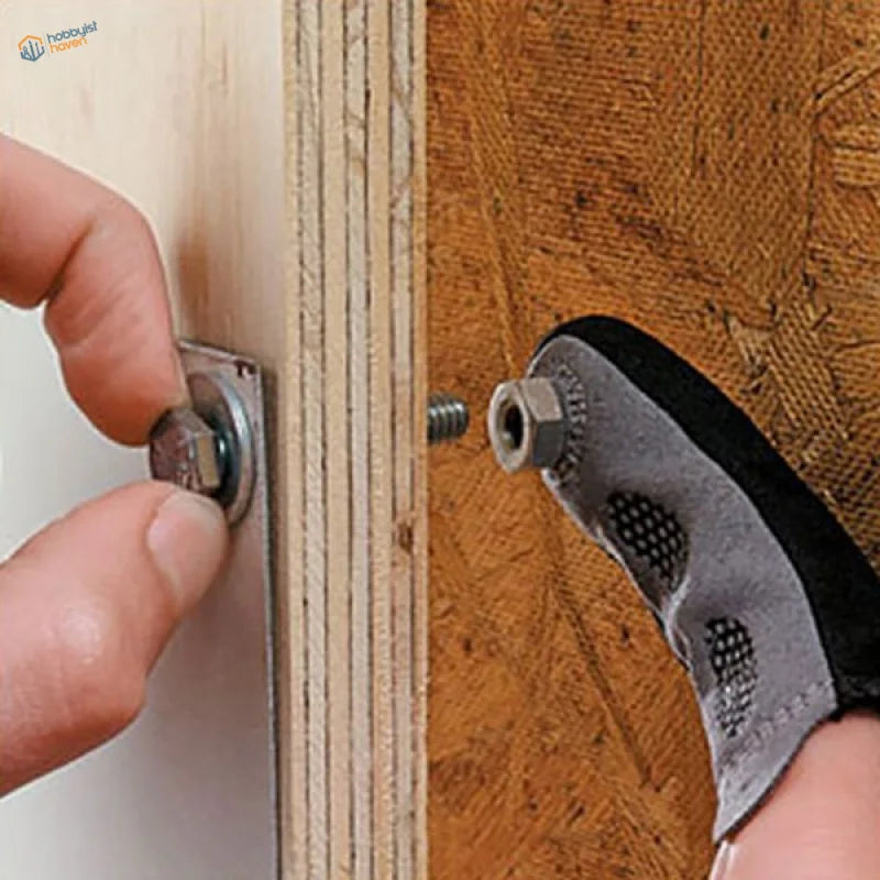 Magnetic fingertip holding silver hexagonal bolt on wood for scale modeling