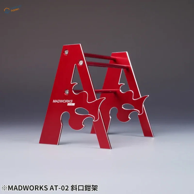 Red metallic A-shaped metal holder for pliers with Madworks flame cutouts
