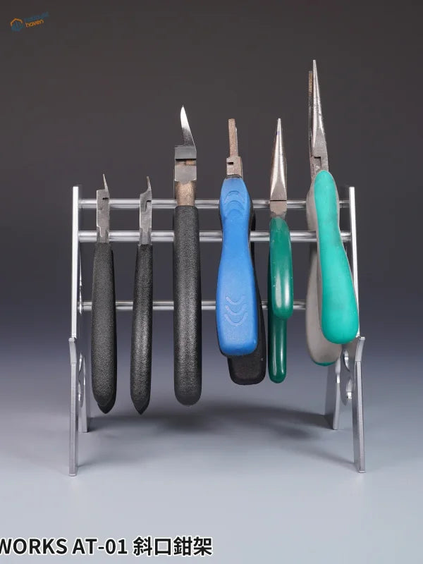 Colorful-handled precision pliers in metal holder for scale modeling tools