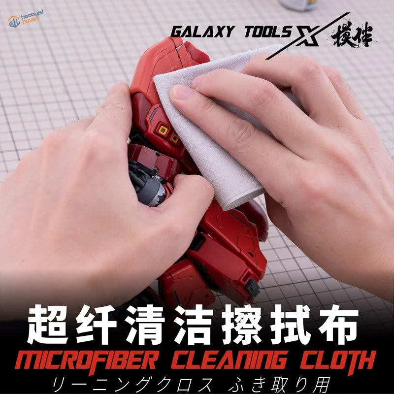 Microfiber cloth removing dust from red plastic robot in scale modeling
