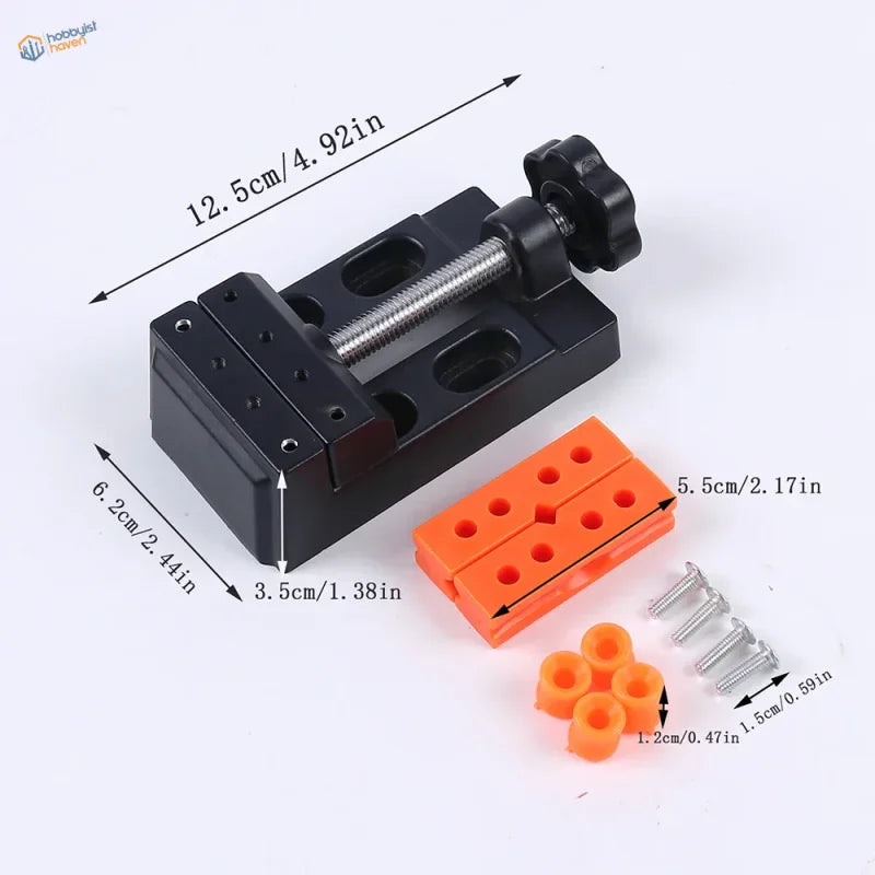 Mini table vise with black plastic and metal body and orange accessories