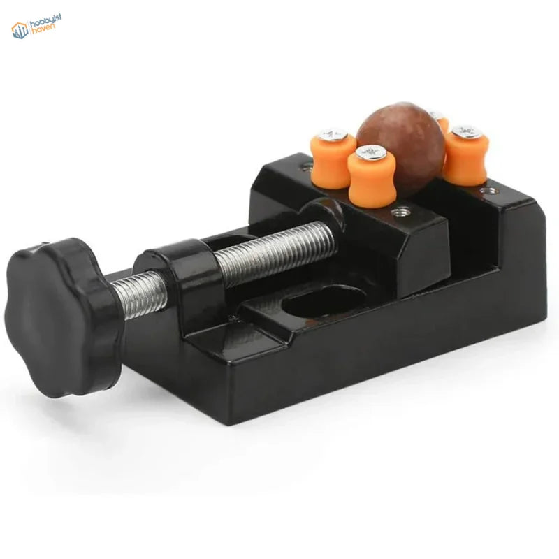 Mini table vise with black metal jaws and orange brown rubber handles