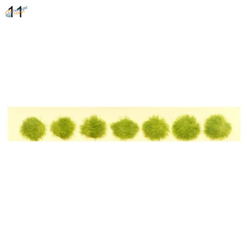 Seven fuzzy green miniature flower clusters in a row