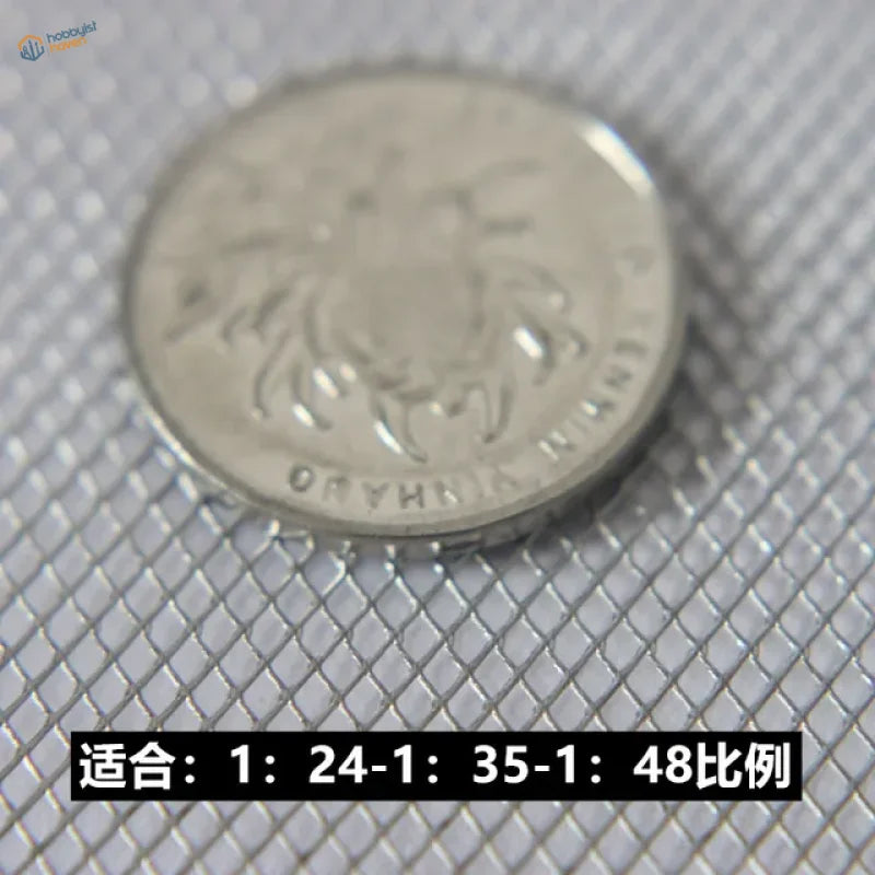 Silver crab coin with Cyrillic text in miniature metal mesh