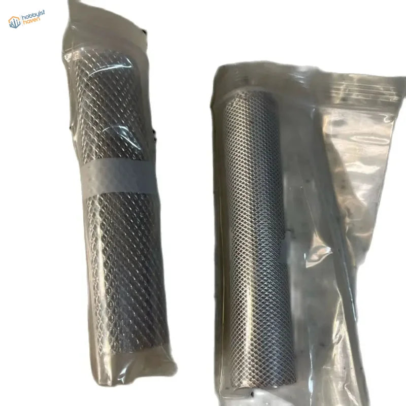 Two miniature metal mesh filters in clear plastic packaging