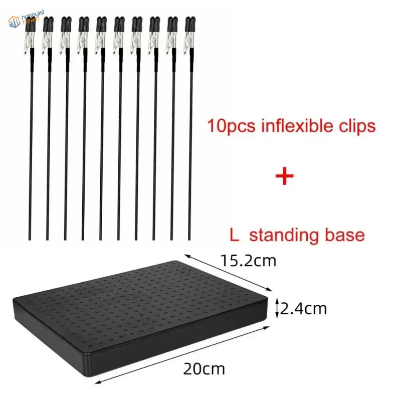 Black plastic l-shaped standing base with grid holes for magnetic alligator clips in airbrush holder for modelists