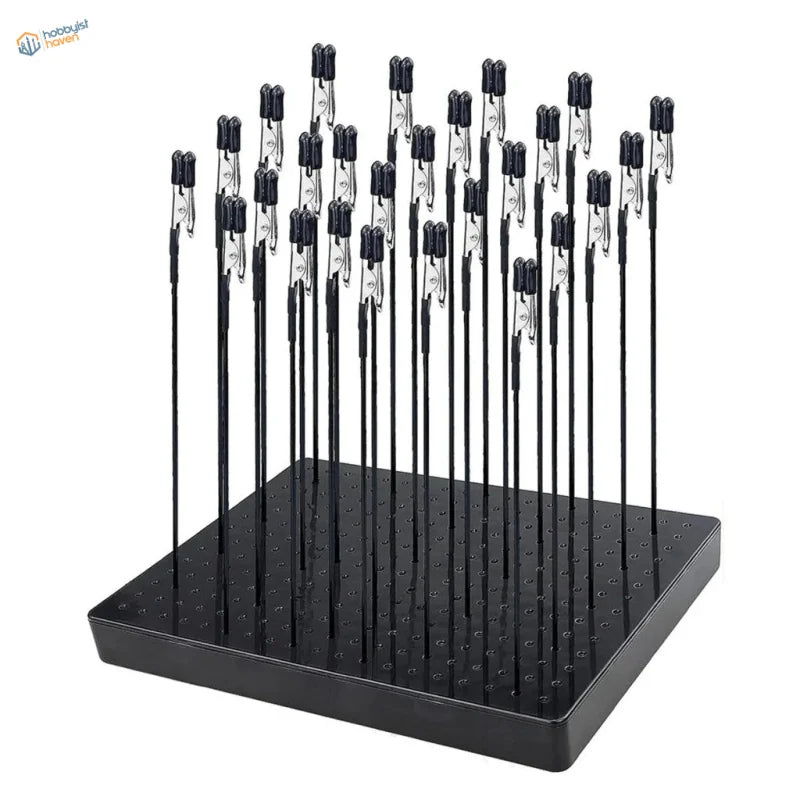 Black plastic model painting clip and stand system with multiple vertical rods and magnetic alligator clips for airbrush use